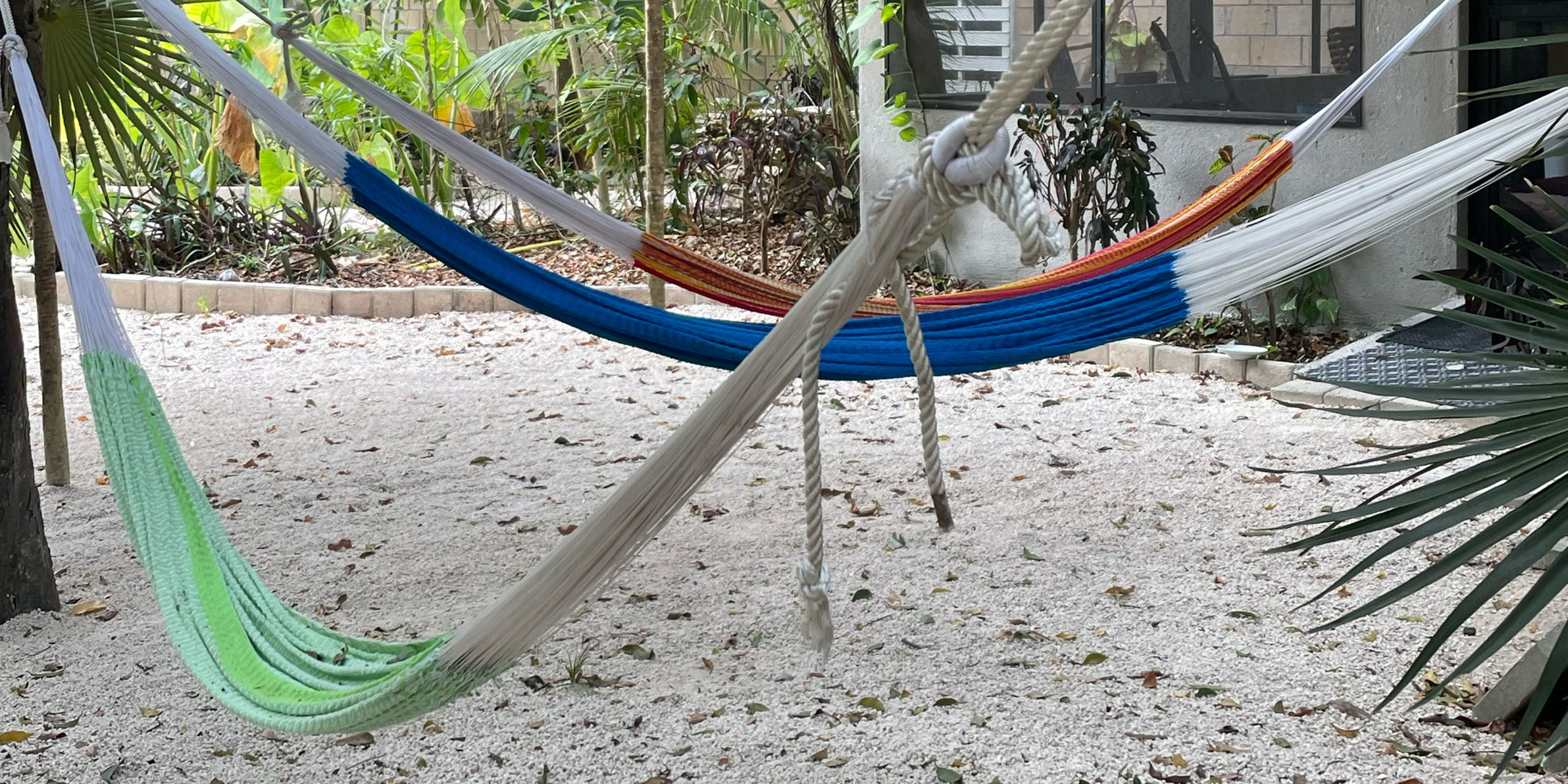 3 hammocks suspended in the One Breath of Yoga class