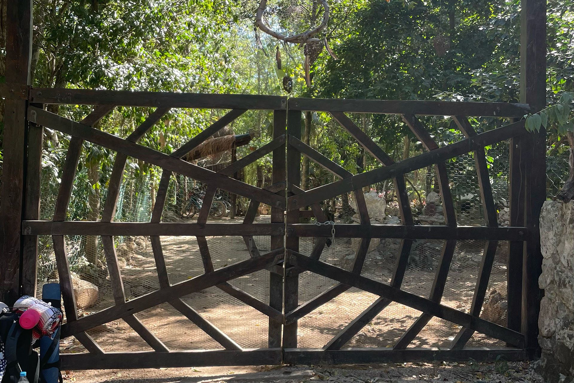 Entrance gate to One breath of Yoga, a large steel barrier with a spider web design